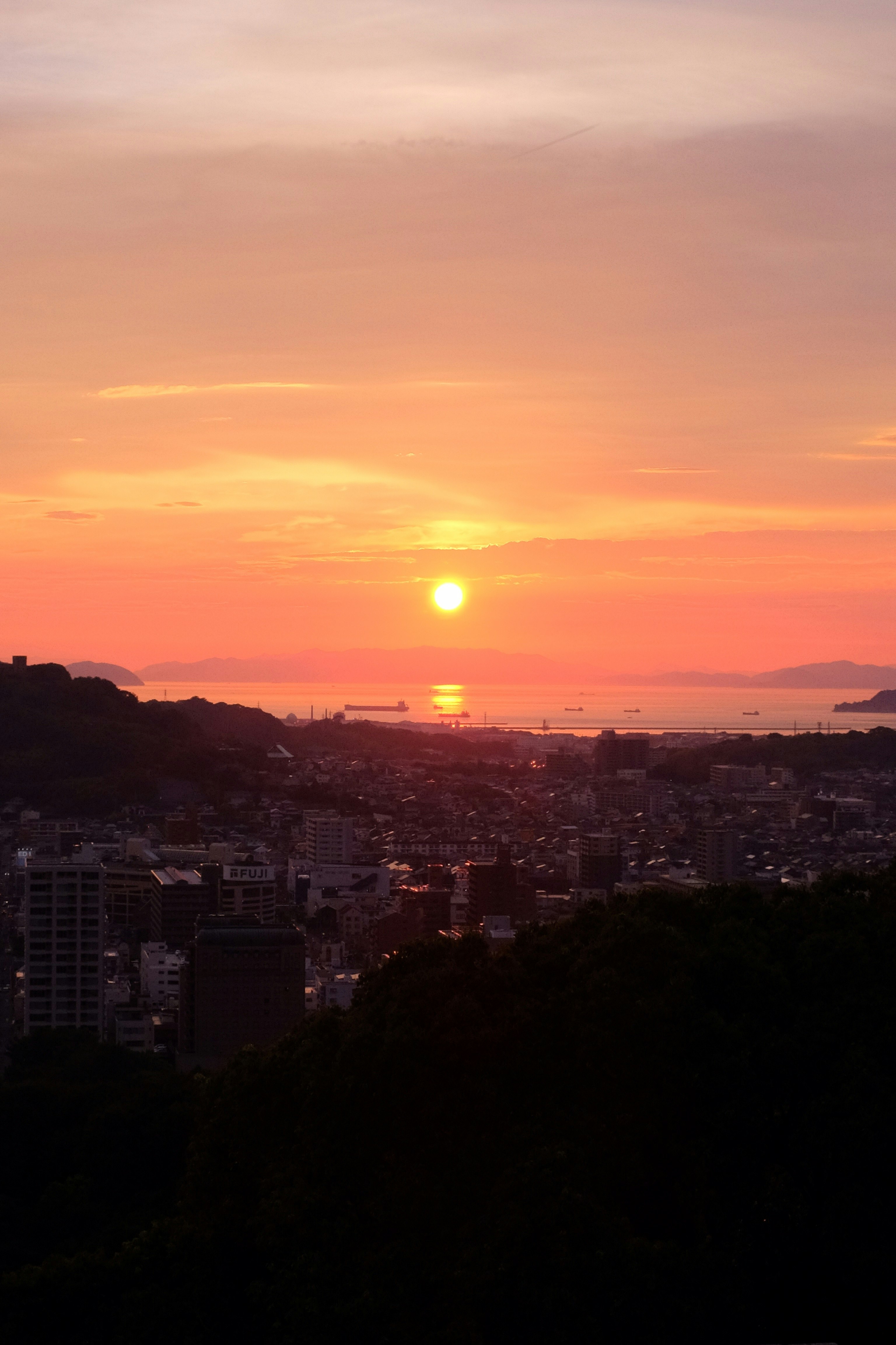 city skyline during sunset with orange sky